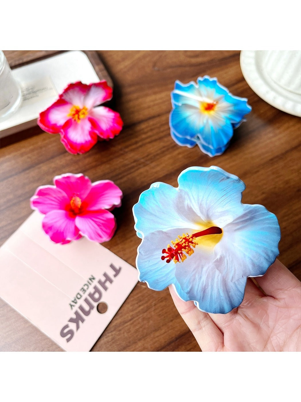 Beau hibiscus claw clip held in hand to show size and shape