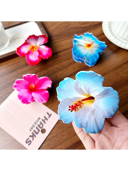 Beau hibiscus claw clip held in hand to show size and shape