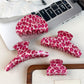 Beau pink leopard print half round claw clip on white background