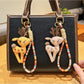Side view of the deer charm keychain showing detailed engraving