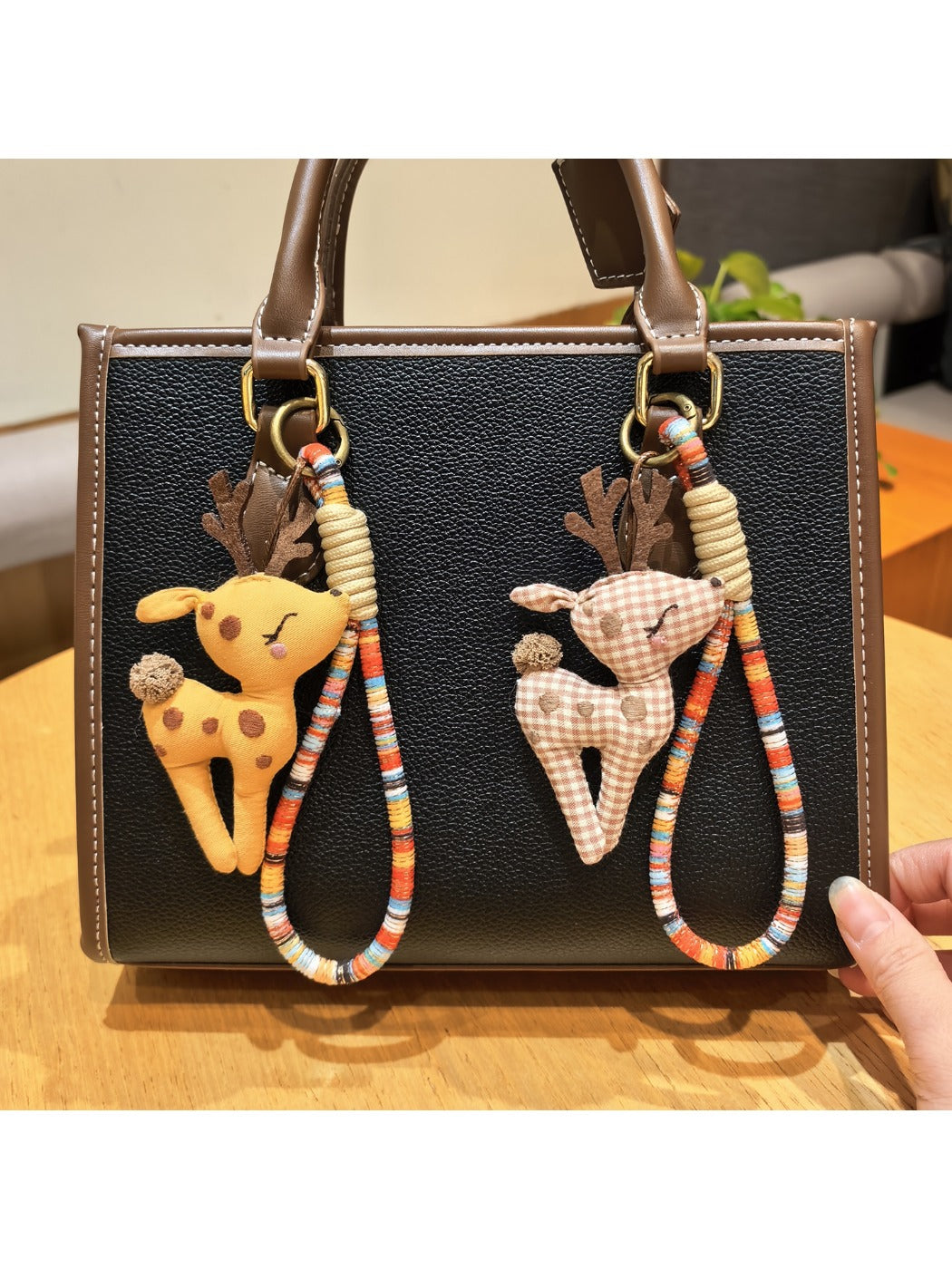 Side view of the deer charm keychain showing detailed engraving