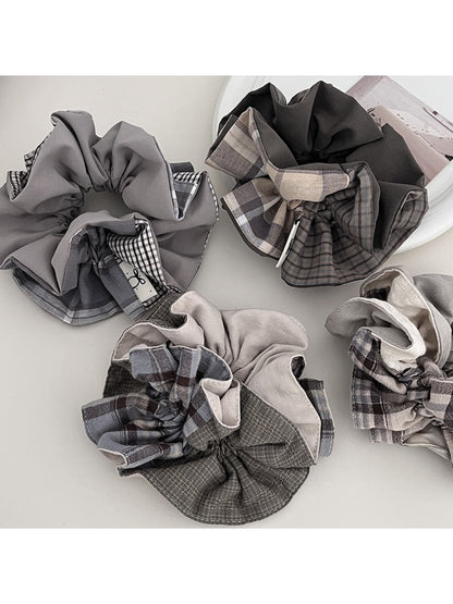 Gifty scrunchie styled on a wrist showing smooth, polished fabric texture