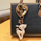 Stylish deer charm keychain displayed with other metallic accessories