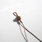 Brown cartoon keychain with a glossy surface and cartoon face