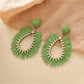 Earedge raffia teardrop hollow earrings shown with matching accessories