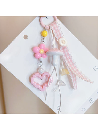 Close-up of pink mushroom keychain showing textured cap and smooth stem details