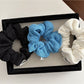 Close-up of Gifty Lazy Style scrunchie showing detailed openwork pattern on fabric