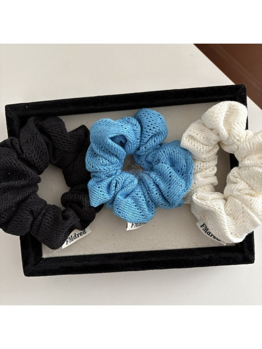 Close-up of Gifty Lazy Style scrunchie showing detailed openwork pattern on fabric