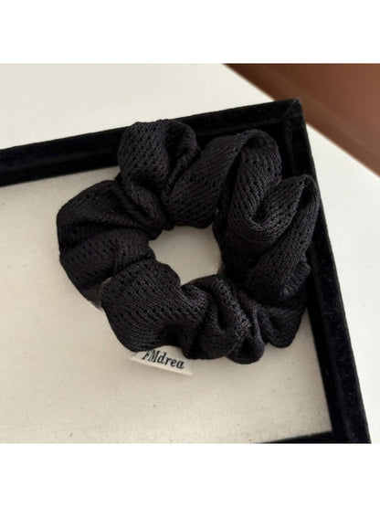 Side view of Gifty Lazy Style openwork scrunchie displaying its elastic stretch