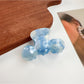 Close-up of Beau hair claw clip teeth gripping thick wavy hair strands