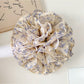 Close-up of Gifty vintage multi layer tiny floral scrunchie with pastel flowers on fabric