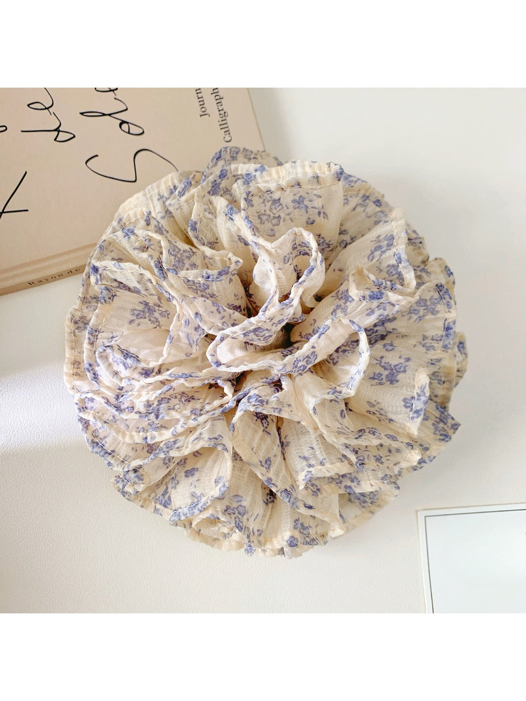 Close-up of Gifty vintage multi layer tiny floral scrunchie with pastel flowers on fabric