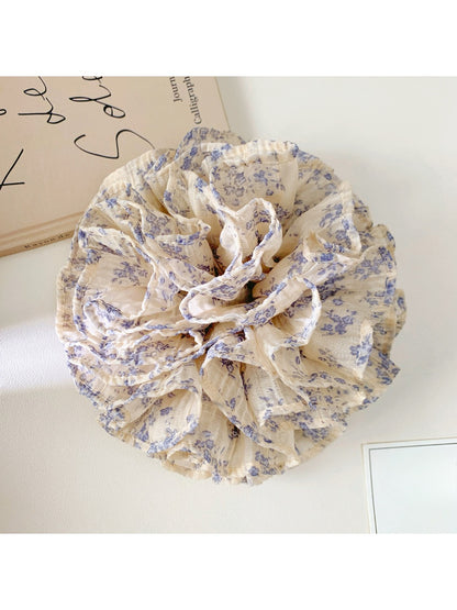 Close-up of Gifty vintage multi layer tiny floral scrunchie with pastel flowers on fabric