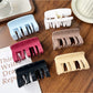 Beau plastic square claw clip open displaying teeth and grip