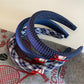 Blue fabric headband with a smooth finish and flexible fit