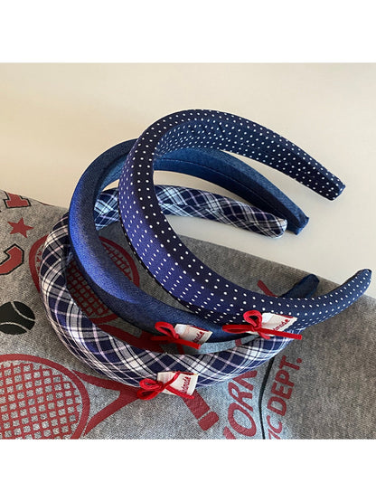 Blue fabric headband with a smooth finish and flexible fit
