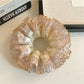 Gifty satin lace trim scrunchie styled in a ponytail on a model