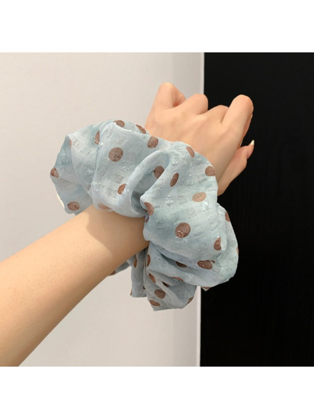 Gifty scrunchie wrapped around a ponytail in a model's hair