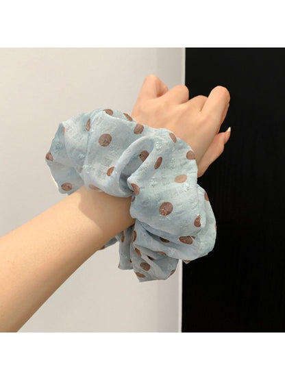 Gifty scrunchie wrapped around a ponytail in a model's hair