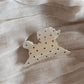 Beau polka dot puppy hair clip photographed with soft lighting emphasizing texture