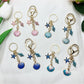 Close-up of Keypus marine inspired pendant keychain with blue and silver design