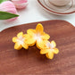Model wearing Beau Sweet Three Flower Hair Claw Clip with loose hairstyle