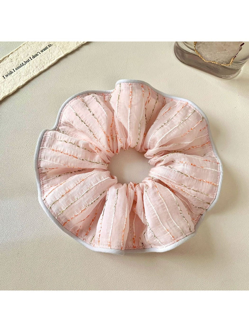 Pink striped hair scrunchie styled with casual outfit accessories