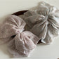 Side view of Beau chiffon bow shaped claw clip highlighting bow shape and clasp
