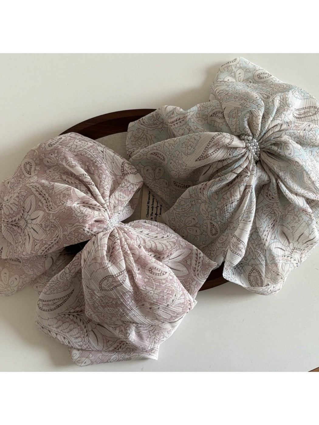 Side view of Beau chiffon bow shaped claw clip highlighting bow shape and clasp