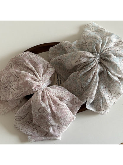Side view of Beau chiffon bow shaped claw clip highlighting bow shape and clasp