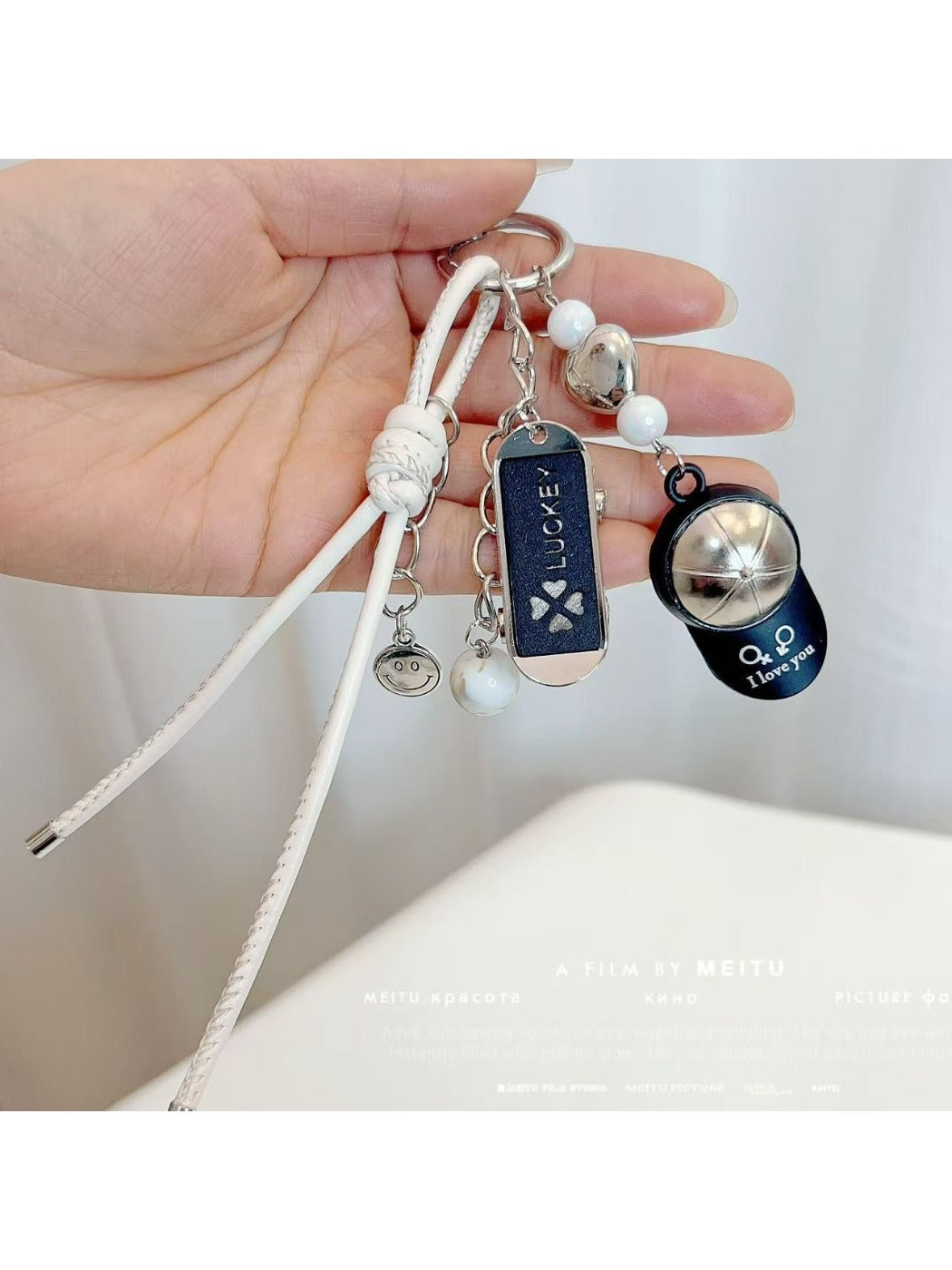 Baseball cap keychain attached to a set of keys on a wooden surface