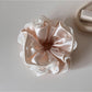 Beige satin scrunchie with lace trim shown from above
