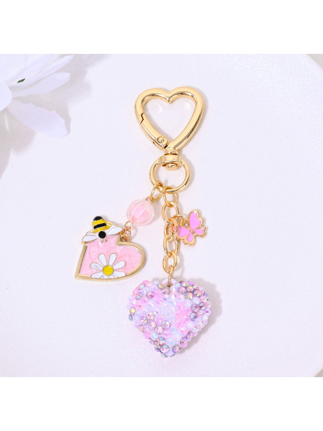 Rhinestone heart keychain held in hand to show size and sparkle