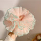 Close-up of Gifty minimalist sweet ruffle scrunchie in soft pink fabric