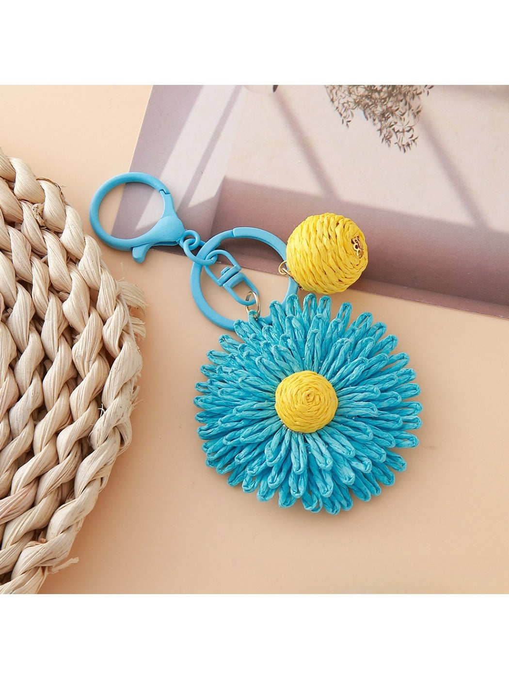 Sunflower keychain hanging from a bag strap outdoors
