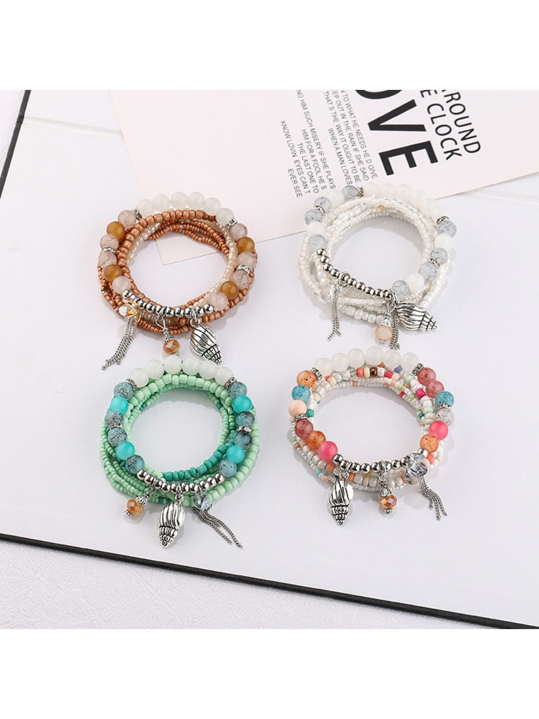 Lovra alloy pendant beaded bracelet with silver beads and a round alloy charm on a white background