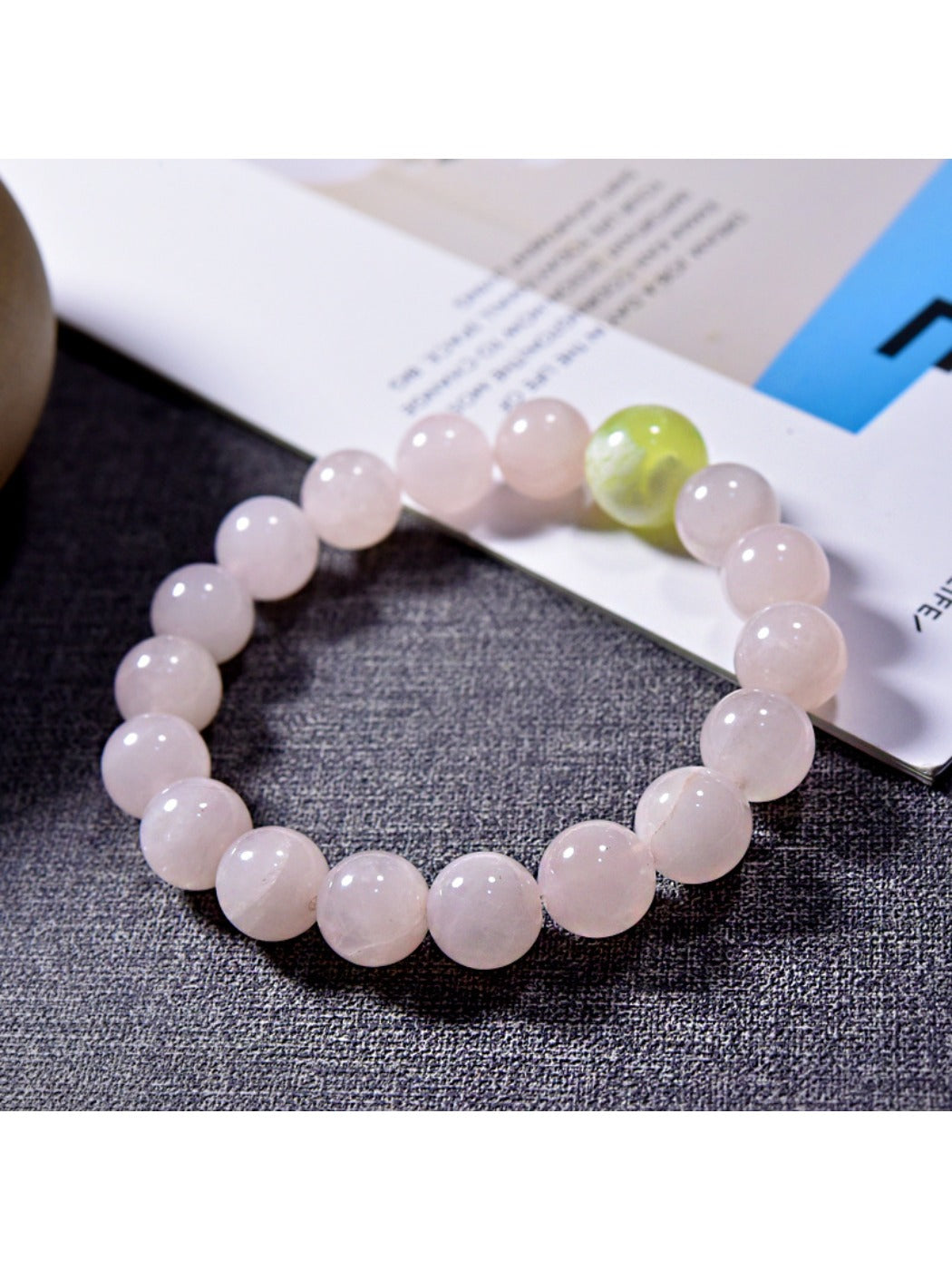 Lovra pink crystal beaded bracelet displayed on a wooden surface with soft lighting