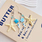 Side view of gold starfish keychain highlighting textured surface and clasp