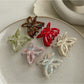 Beau acetate butterfly shaped claw clip in tortoiseshell pattern on white background