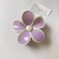 Beau flower claw clip positioned to show both top flower design and side clasp