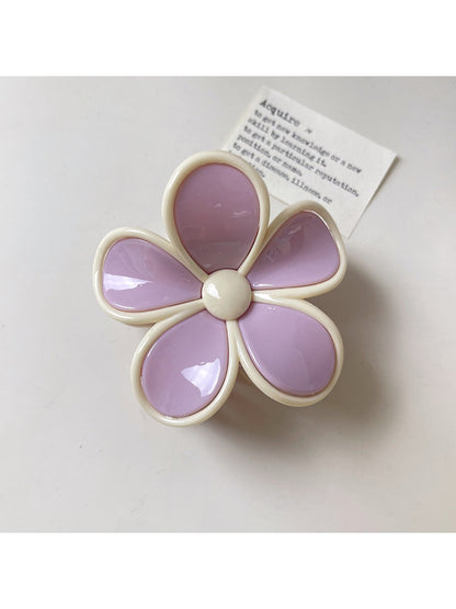 Beau flower claw clip positioned to show both top flower design and side clasp