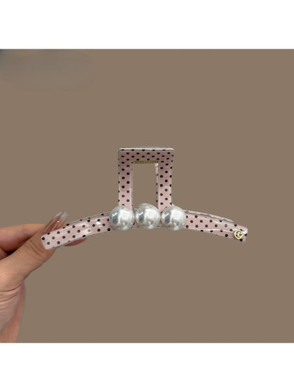 Beau pink hair clip with white polka dots, rectangular shape, glossy finish