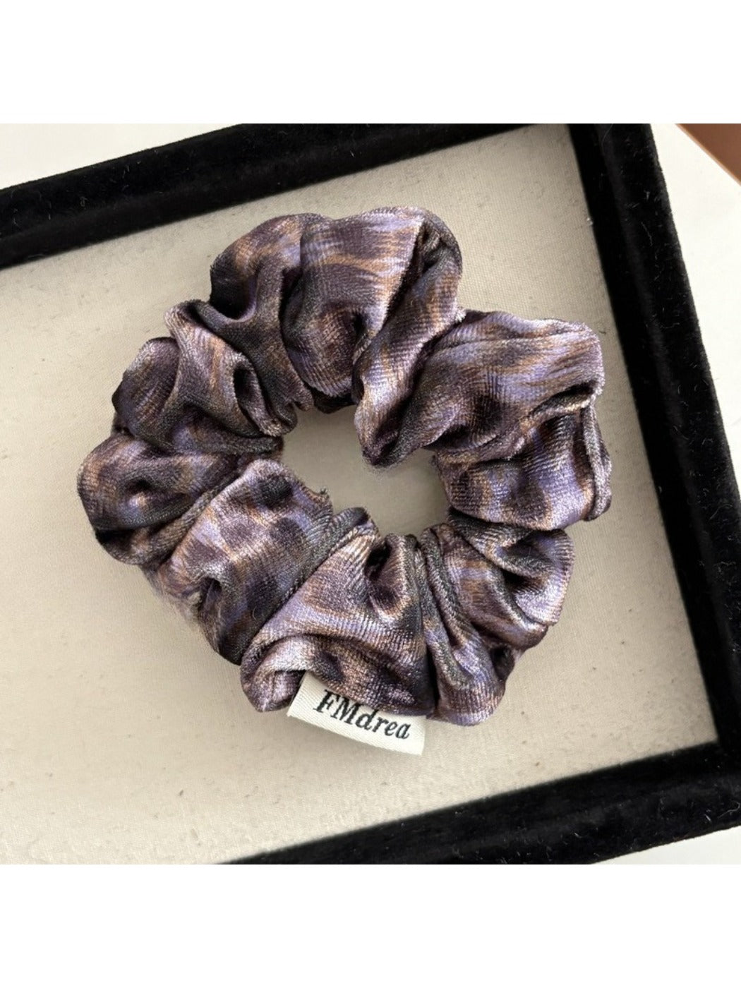 Multiple Gifty Dreamy Silky Retro Scrunchies in various pastel colors arranged in a circle