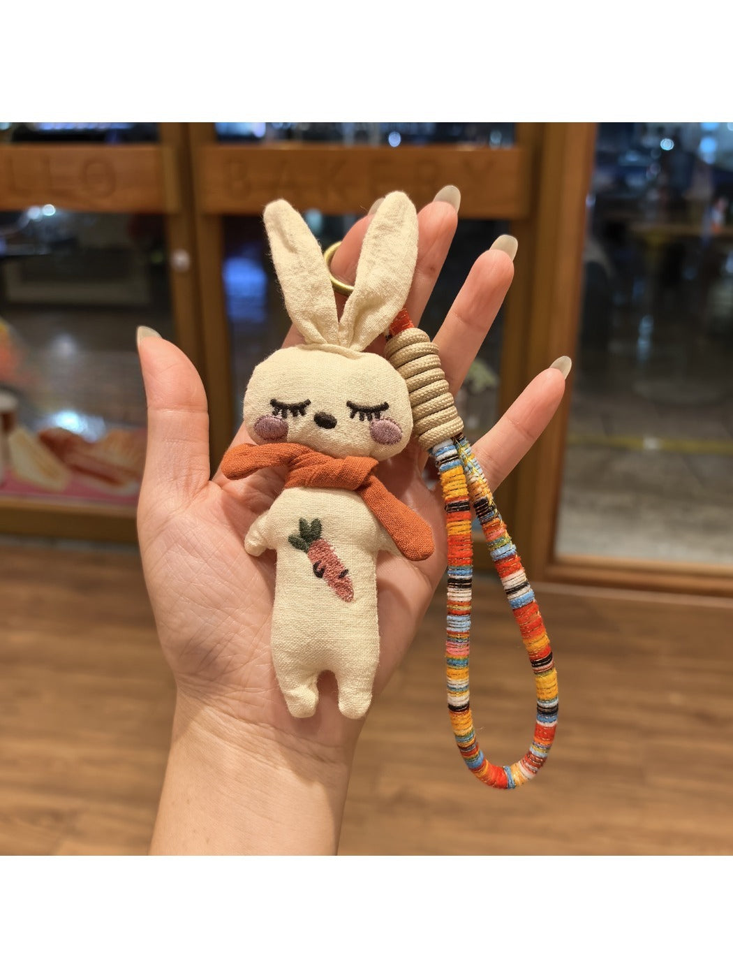 Vintage rabbit charm keychain hanging from a set of keys on a wooden surface