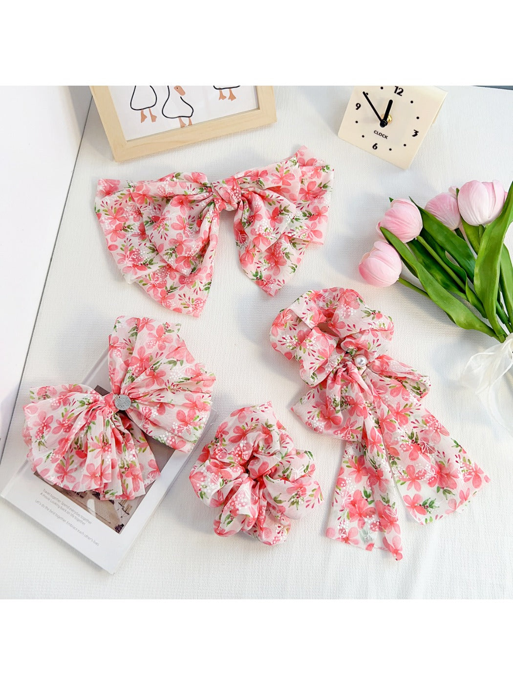 Red floral print bow scrunchie on a white background