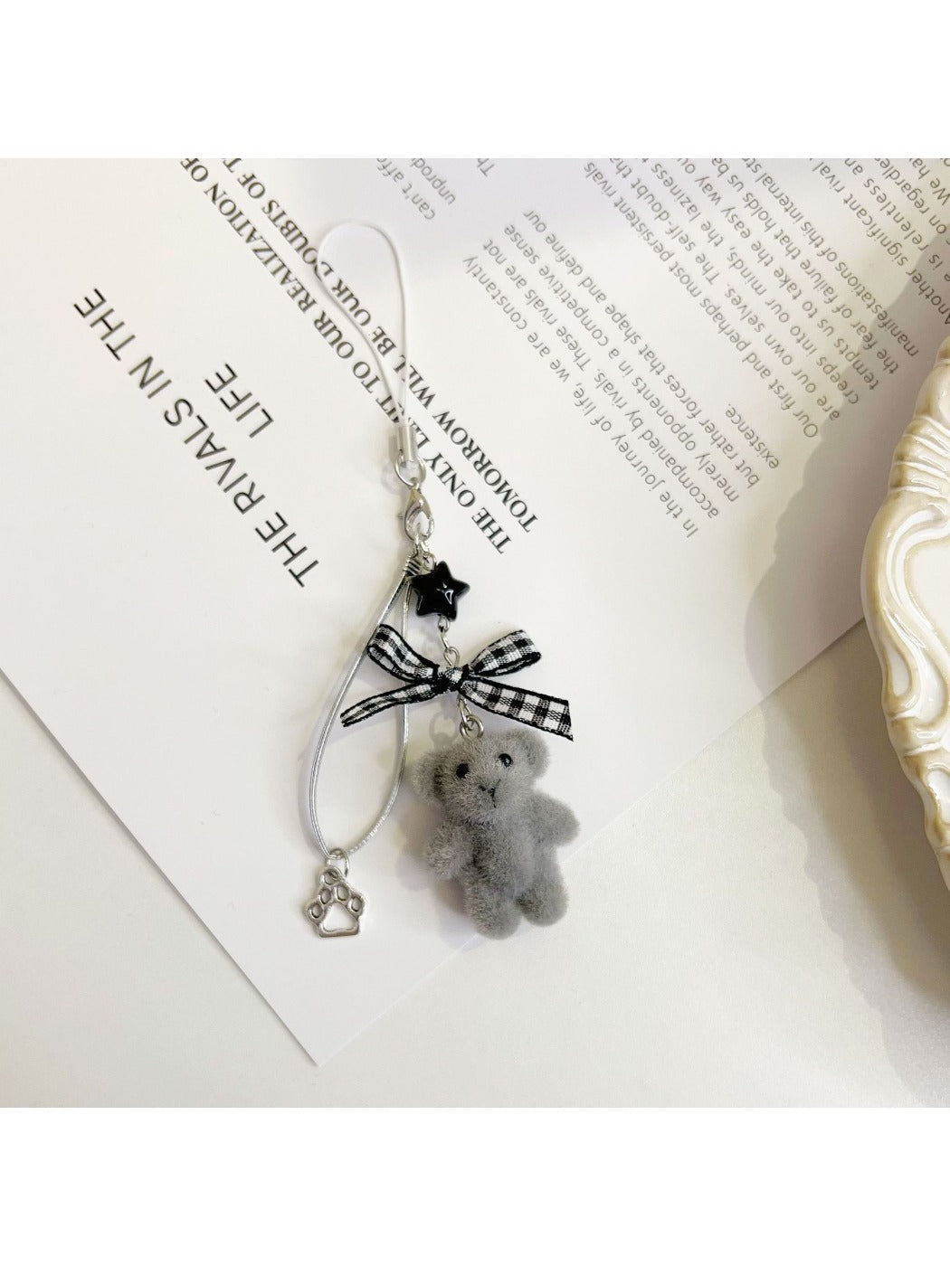 Keypus bear bag charm keychain photographed against a pastel background