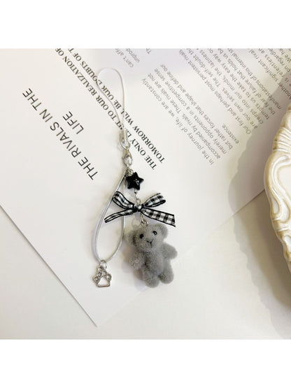Keypus bear bag charm keychain photographed against a pastel background