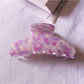 Beau chic tiny floral acetate claw clip close-up on floral pattern details