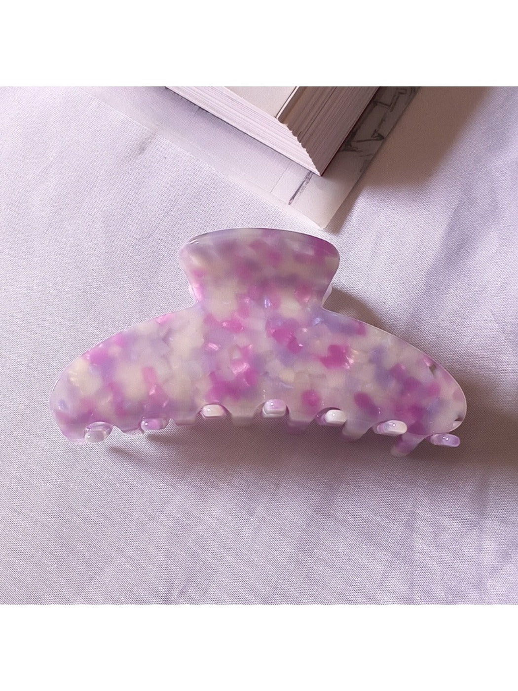 Beau chic tiny floral acetate claw clip close-up on floral pattern details