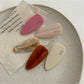Beau pink tone hair clip clipped onto brown hair
